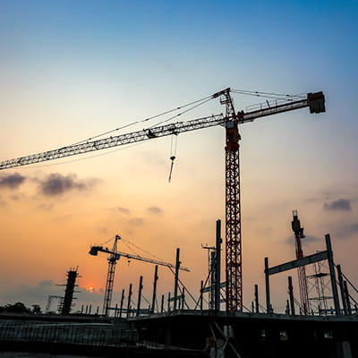 Cranes on construction site at dusk